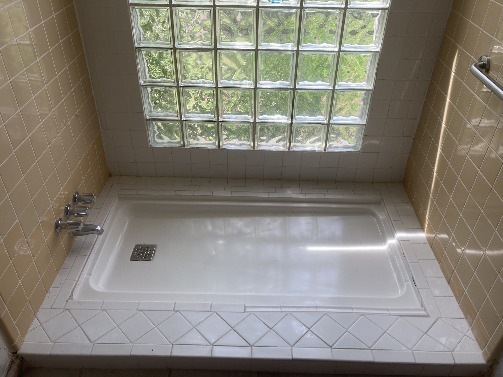 Finished bathroom with tiled tub surround Austin