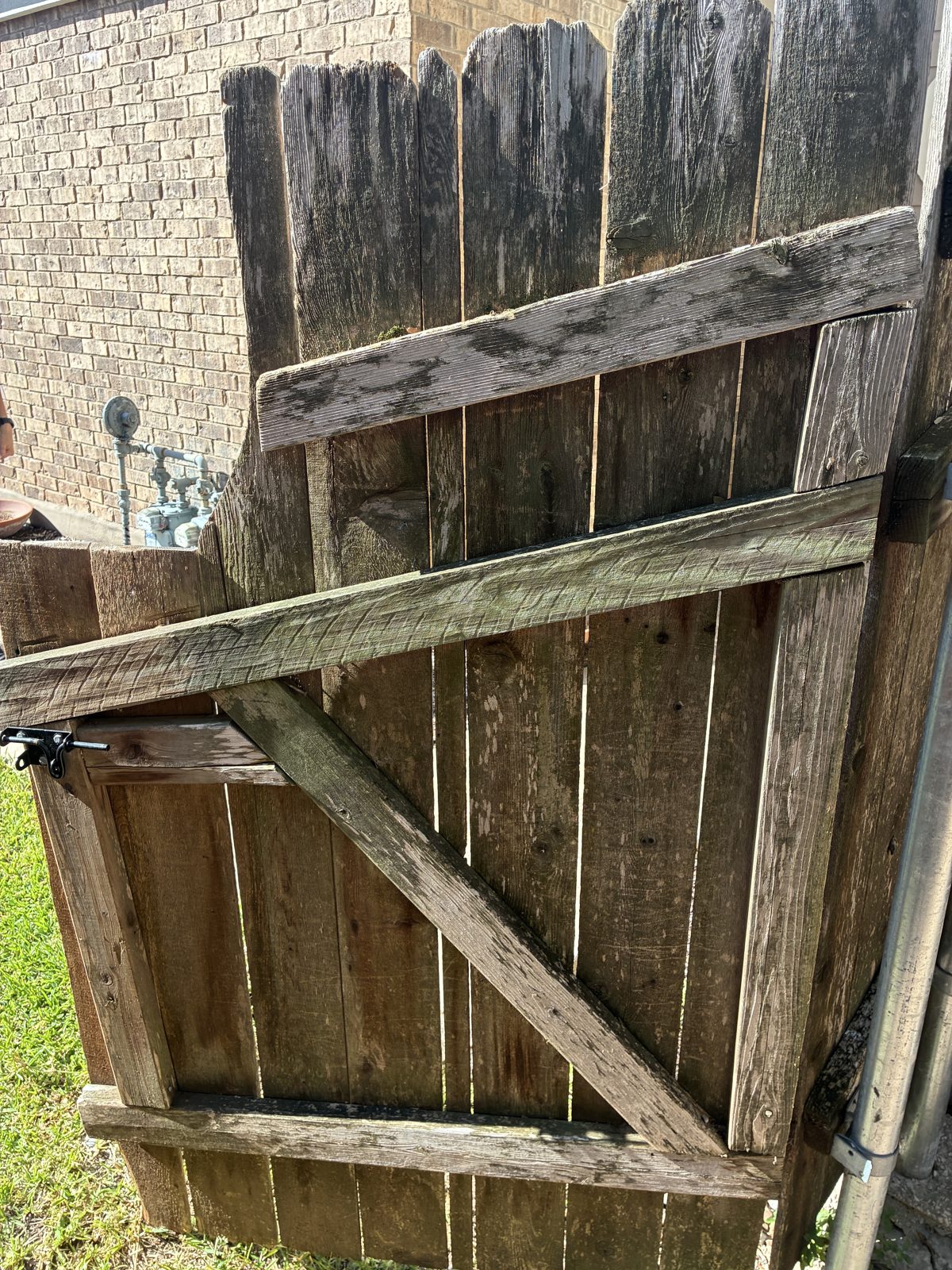 Weathered cedar gate before staining and repair Austin TX