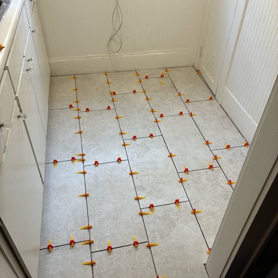 Kitchen tile floor installation in progress