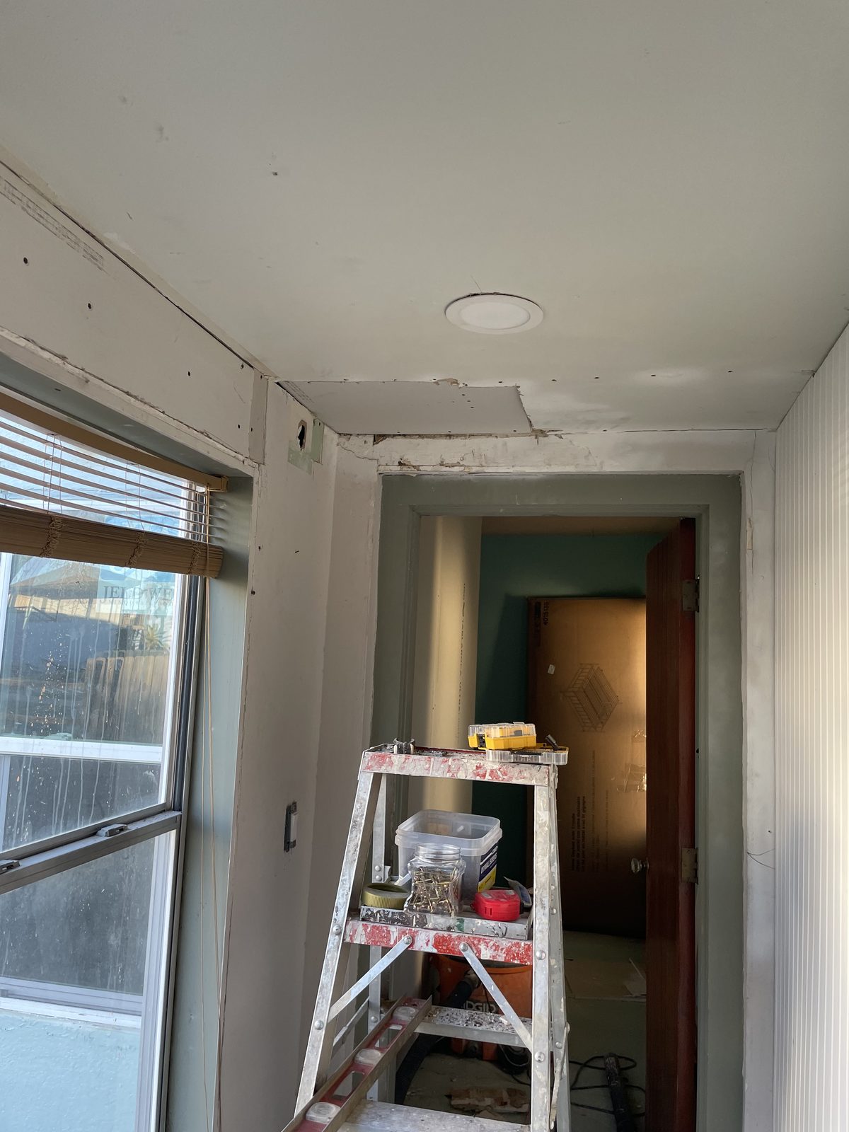 Hallway door and trim repair in progress